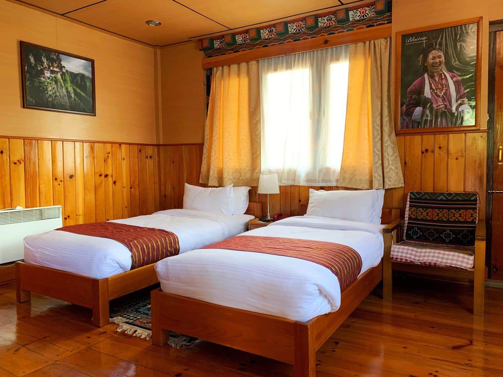 Twin beds in a wood-panelled cottage
