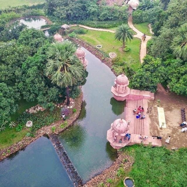 Pink sandstone ghats along a stream, seen from above