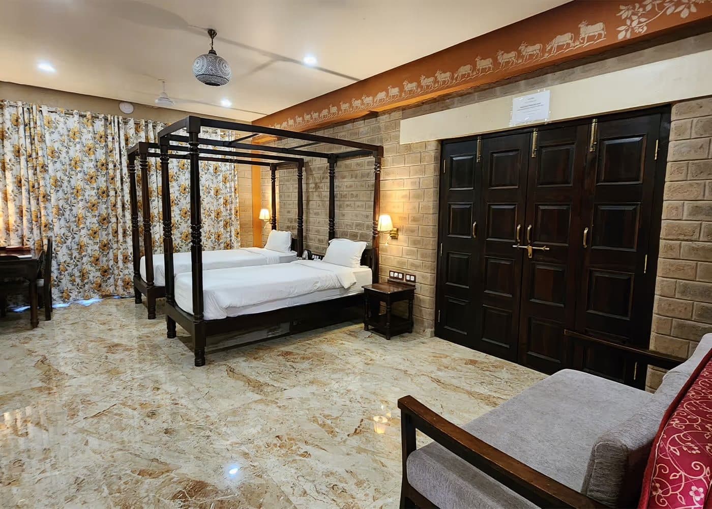 A Mahavan room with twin four-poster beds and a marble floor