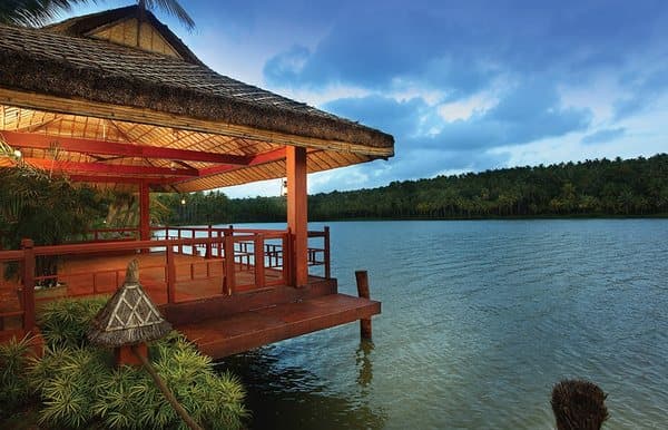 A wooden pavilion on a deck over the lake