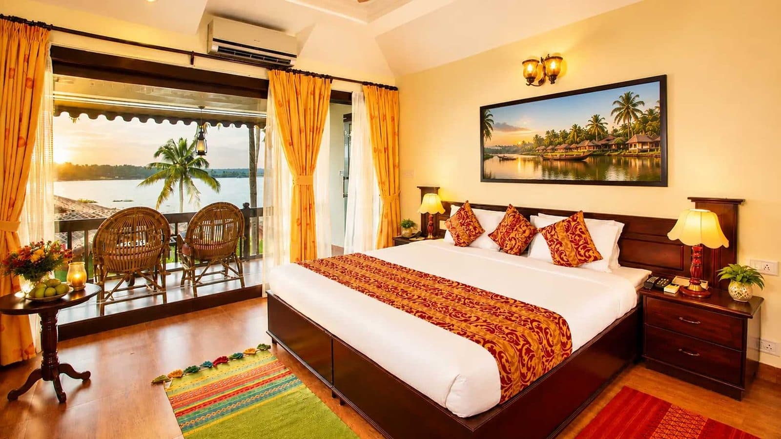 A lake-view bedroom with cane chairs on the balcony