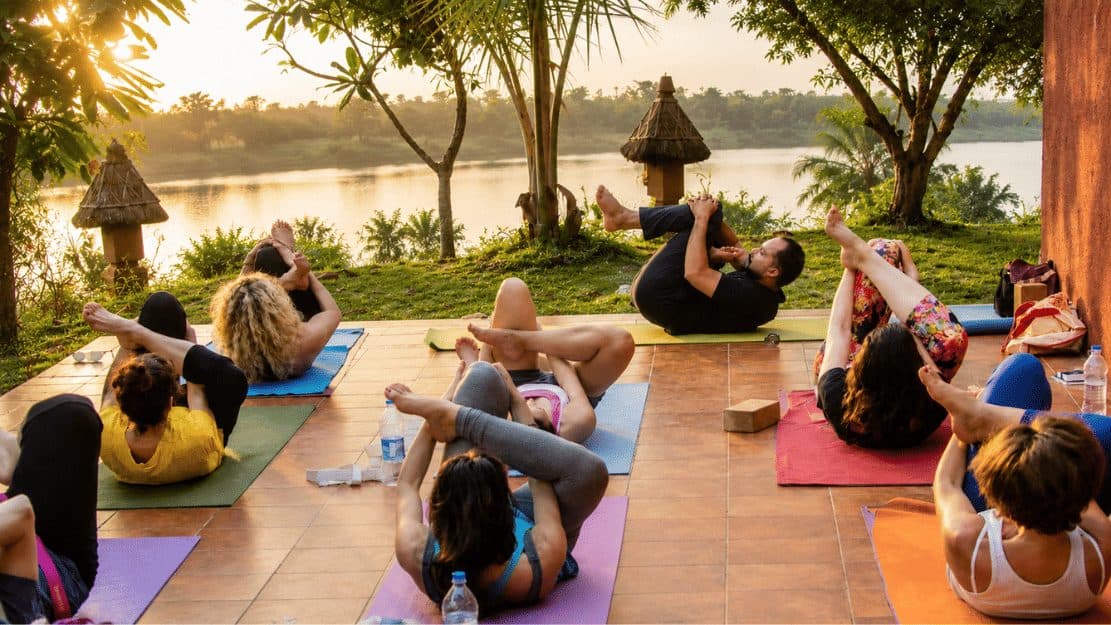 A yoga class on a terrace beside the lake